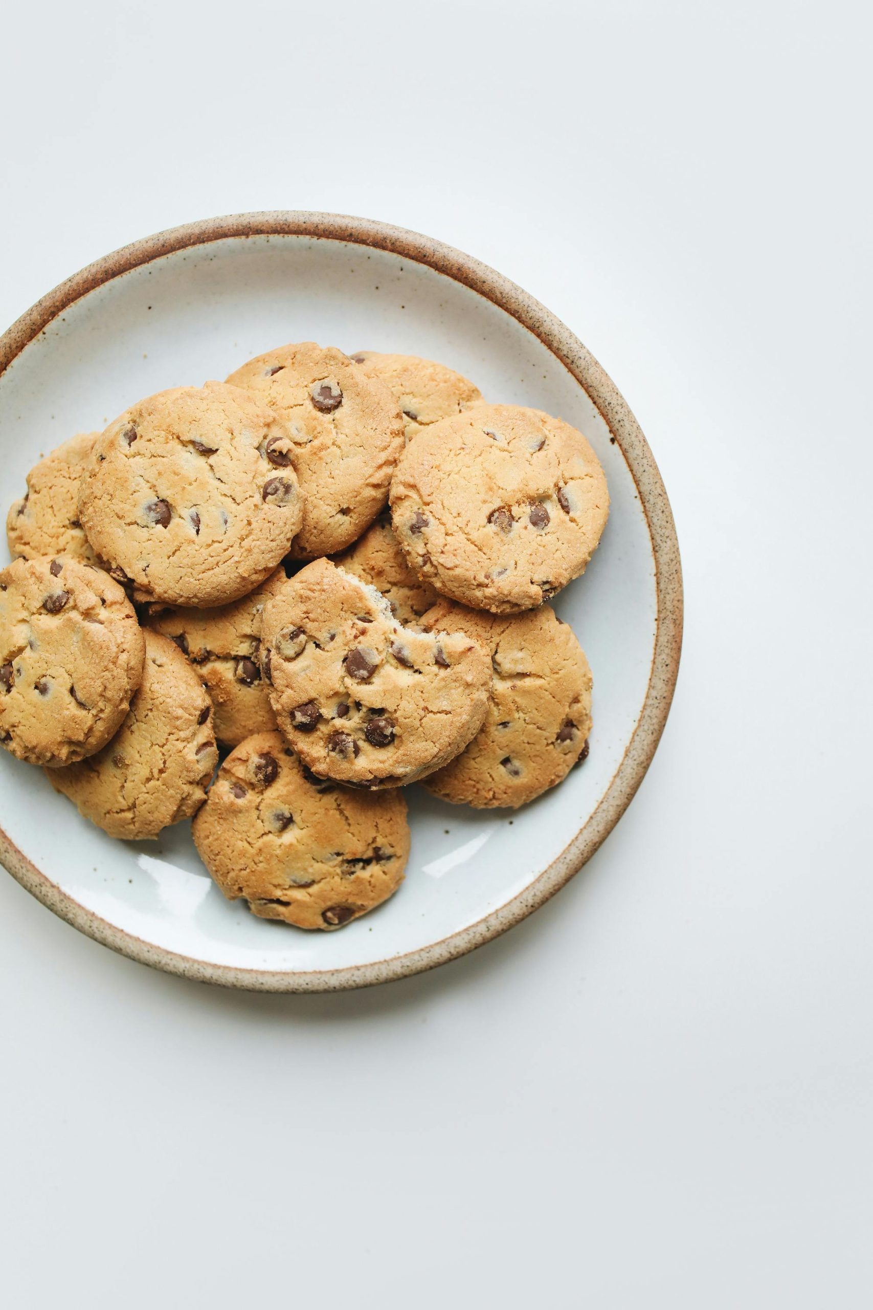 Tasty chocolate chip cookies arranged on a ceramic plate for a delightful snack.
